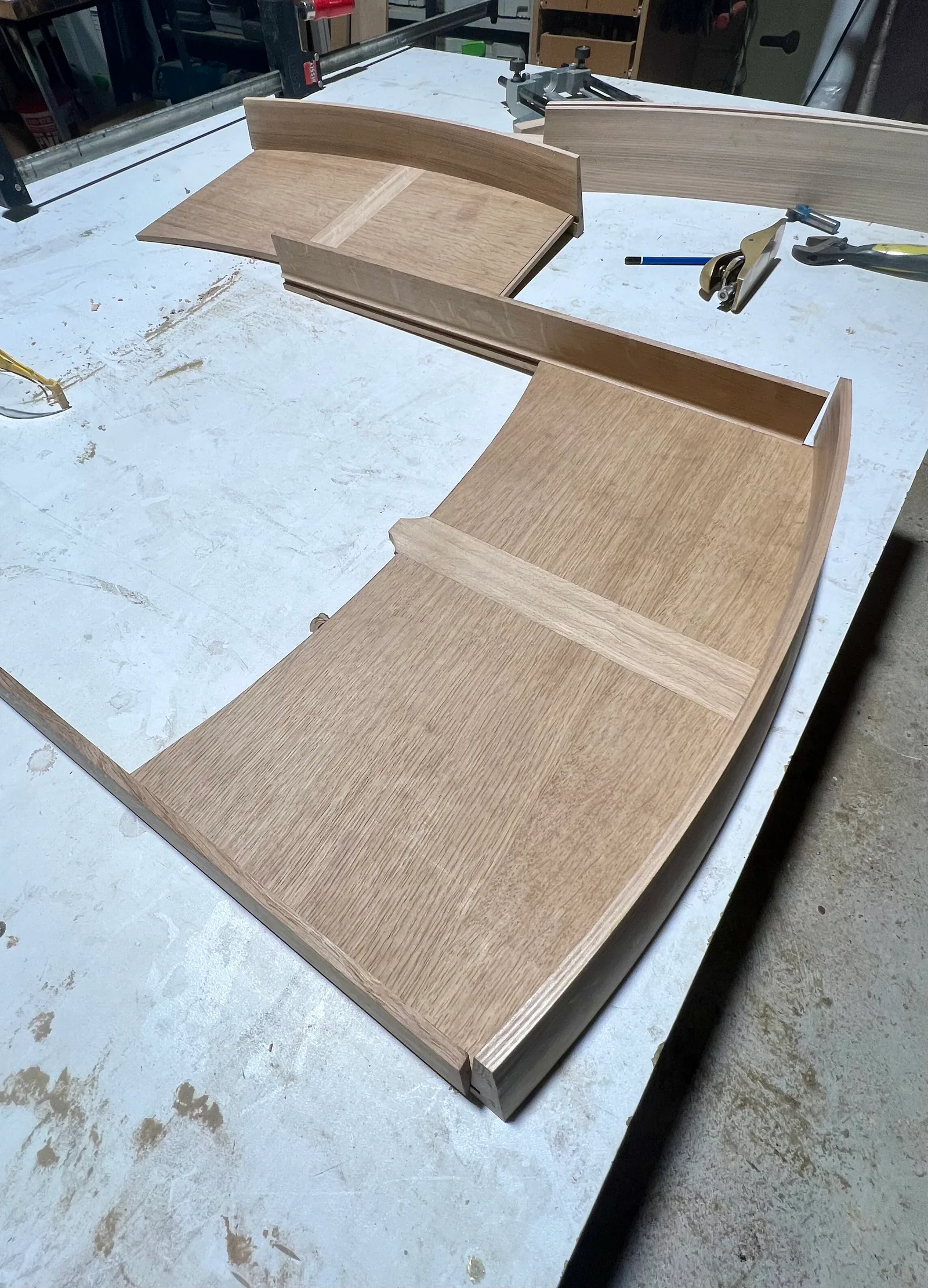 Curved timber fronts on the bench with the forming jig alongside