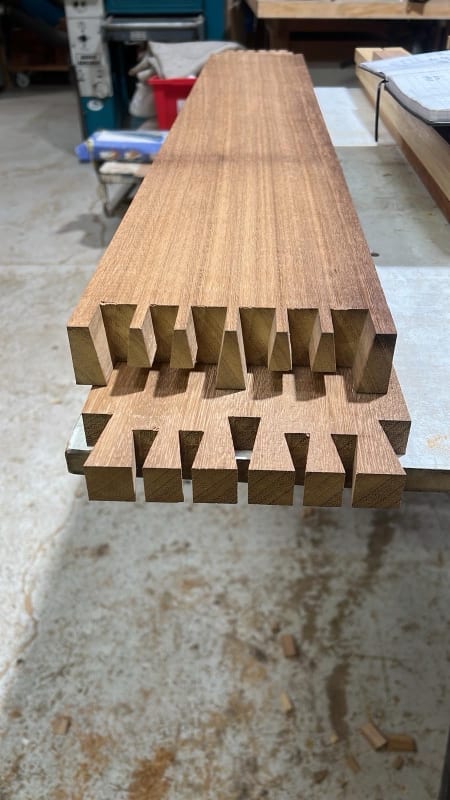 Hand-cut timber joints in long rails on the workshop trestles