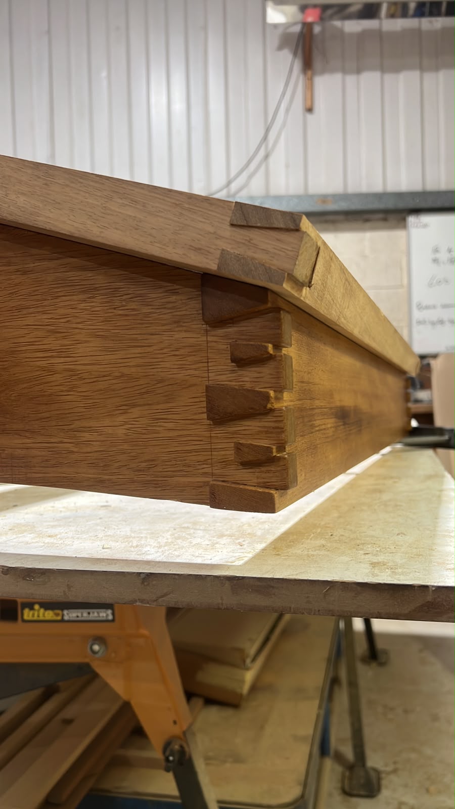 Hand-cut dovetail joints on a bespoke hardwood cabinet in the workshop